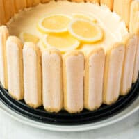 no bake lemon cheesecake with ladyfingers on a platter with recipe name at the bottom