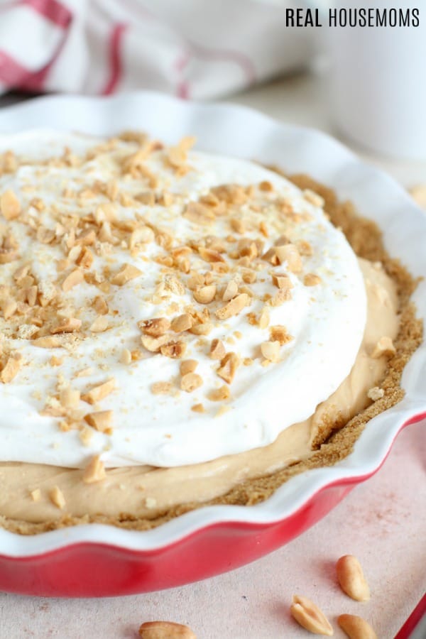 no bake peanut butter pie in pie dish topped with peanuts