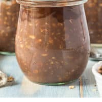 side view of nutella overnight oats in a jar with recipe name at the bottom