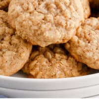 oatmeal cookies piled on a plate with recipe name at the bottom