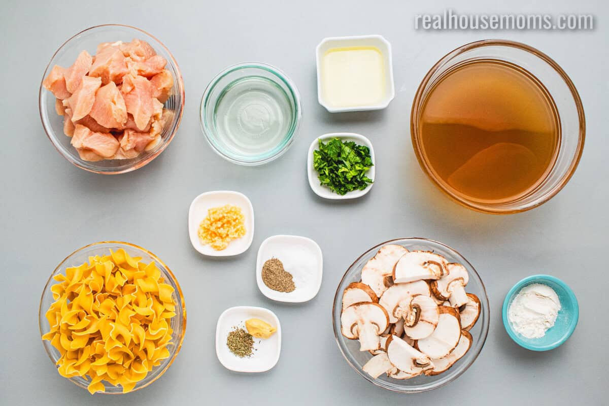 ingredients to make chicken stroganoff in bowls on a counter