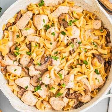 square image of one pan chicken stroganoff topped with chopped parsley in a skillet