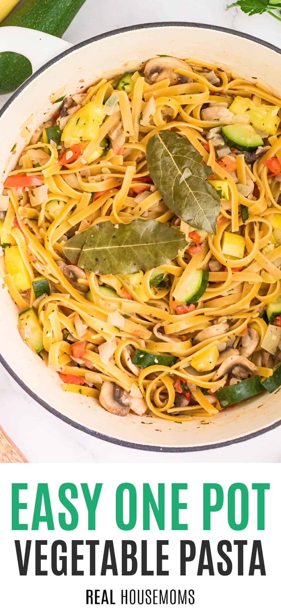 one pot vegetable pasta with bay leaves on top in a dutch oven with recipe name at the bottom