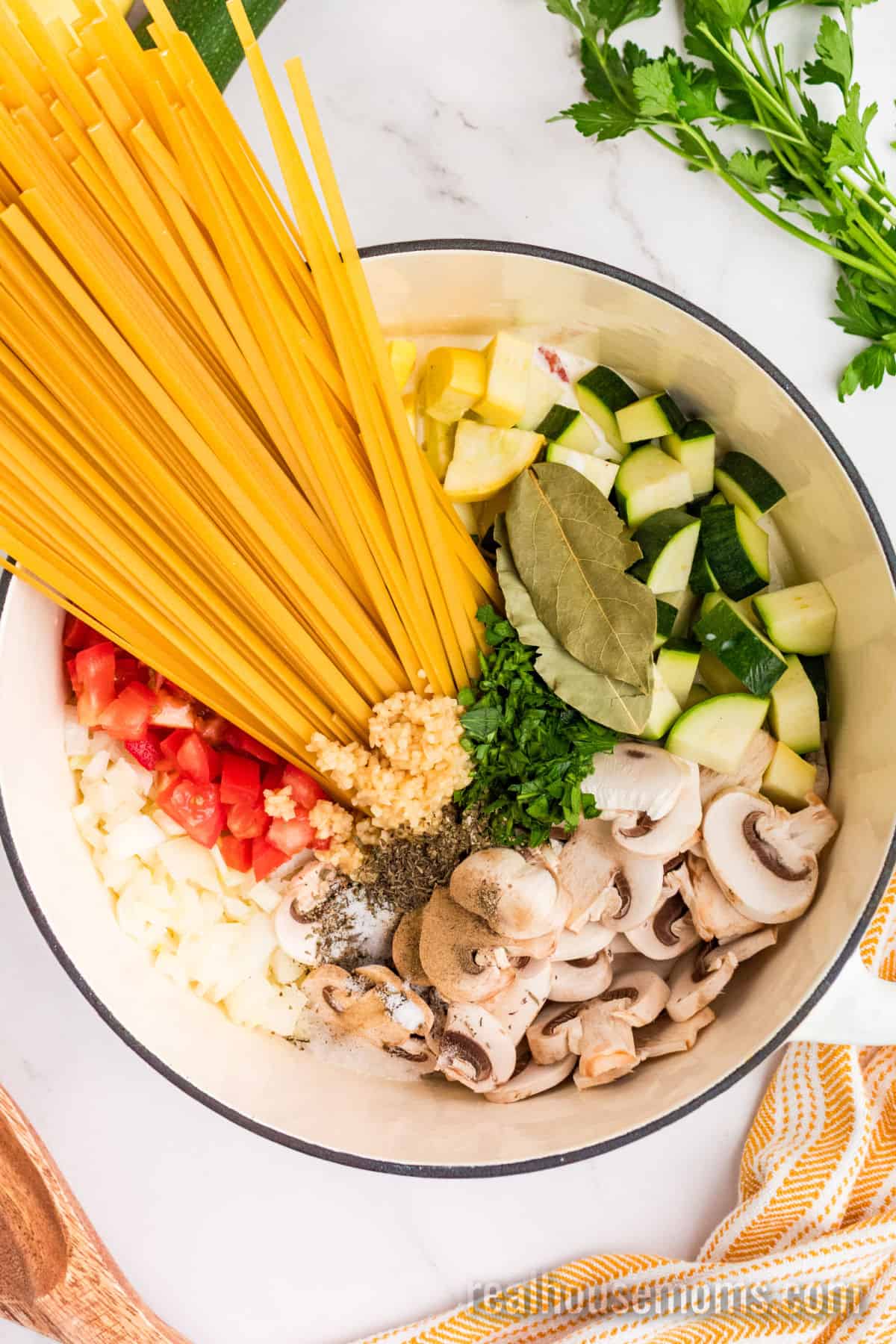 all one pot vegetable pasta ingredients in a white dutch oven before cooking