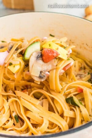 spoonful of one pot vegetable pasta being taken from the pot
