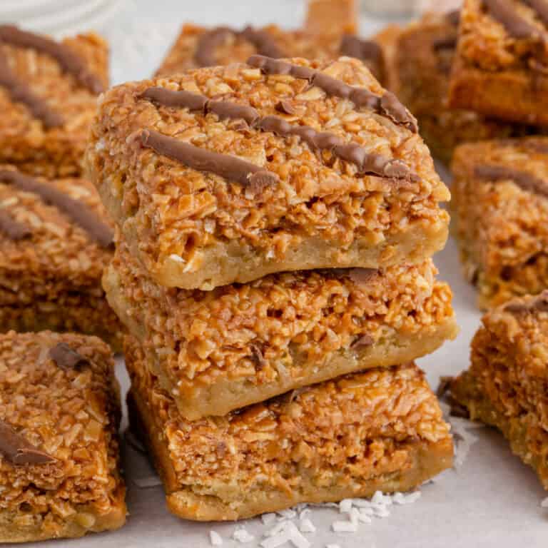 square image of stacked ooey gooey samoas blondies