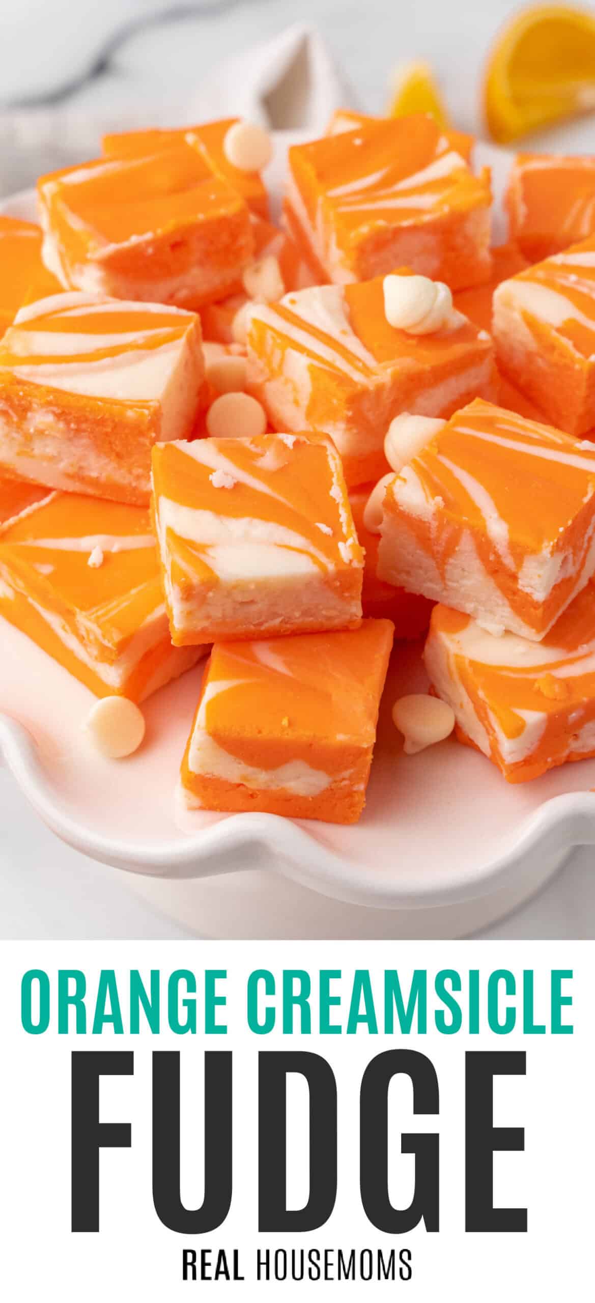 orange creamsicle fudge piled on a cake stand with recipe name at the bottom