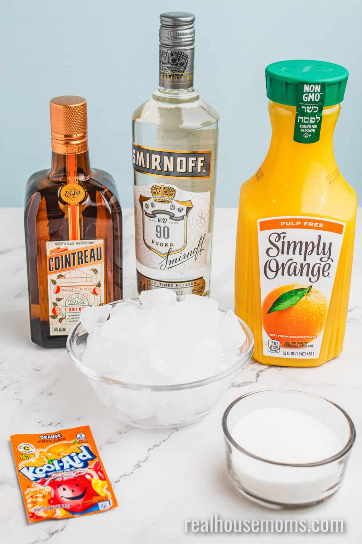 ingredients to make orange vodka slush on a counter