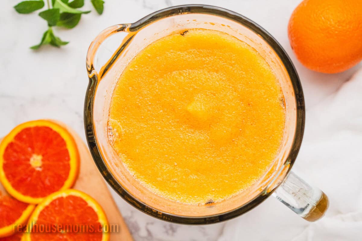 looking down at a pitcher of orange vodka slush
