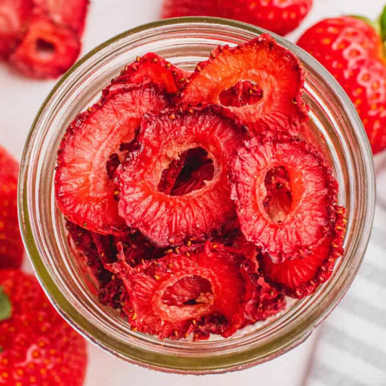 over the top shot of a bowl of oven dried strawberries