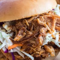 Pulled Pork Sandwiches are the perfect pot-luck food - juicy, smothered in homemade sauce, and topped with chilled coleslaw. Your family and friends will be begging for more!