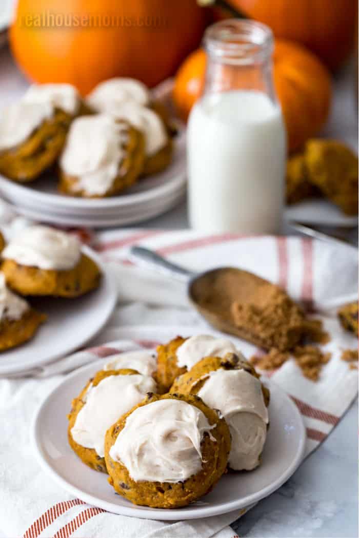 pumpkin cookie on a plate with a bite take out of one