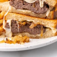 patty melt cut in half and stacked on each other with recipe name at the bottom