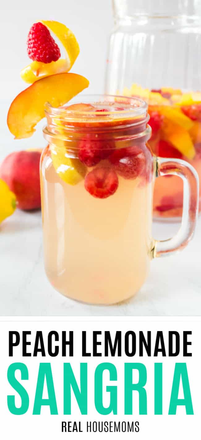 glass of peach lemonade sangria with raspberries and peaches
