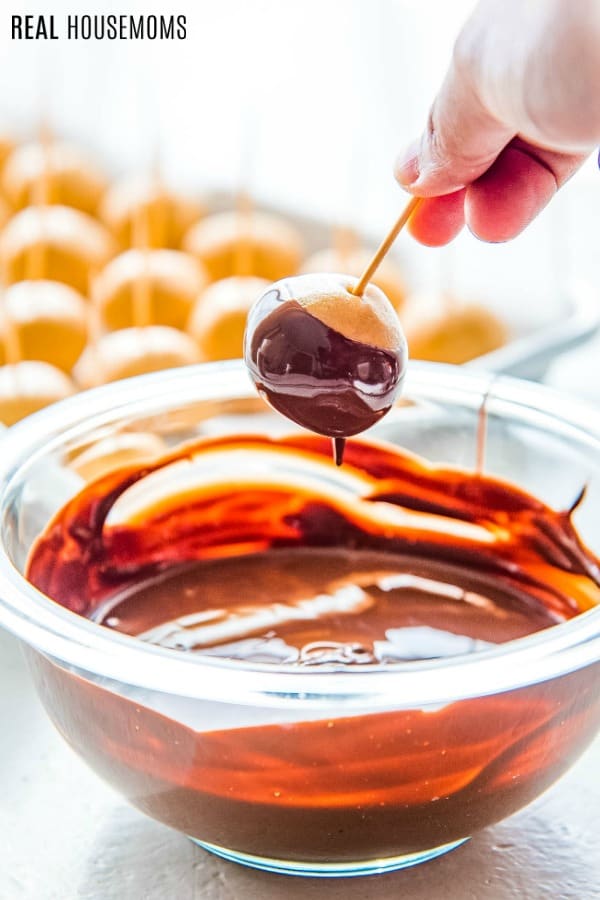 peanut butter balls being dipped in chocolate