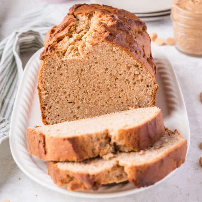 square image of slices of peanut butter bread in front of the loaf on a platter