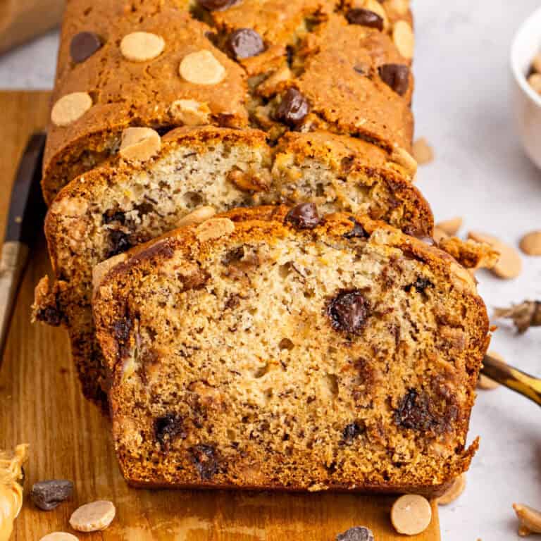 square image of slices of peanut butter chocolate chip banana bread leaning against the loaf