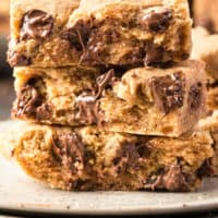 stack of 3 peanut butter chocolate chip bars with recipe name at the bottom
