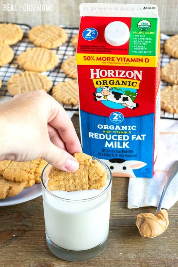 peanut butter cookie being dunked in milk