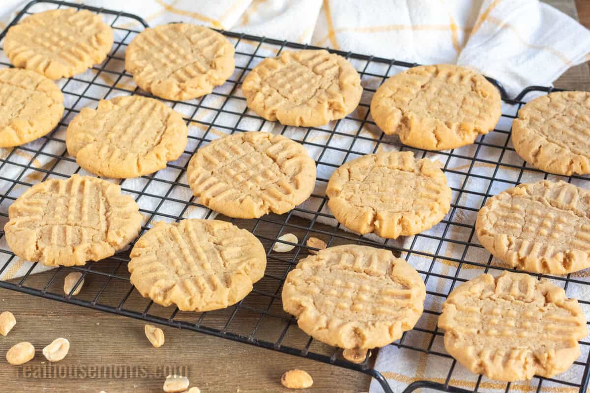 angled view of cooled peanut butter cookies on a wire rack