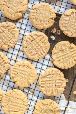 looking down at peanut butter cookies on a wire rack to cool