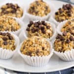 square image of peanut butter protein balls in paper cups on a plate