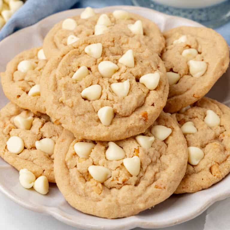 square image of peanut butter & white chocolate chip cookies piled on a plate