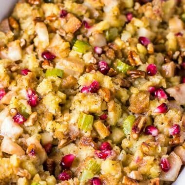 square image of pomegranate pear stuffing in a casserole dish