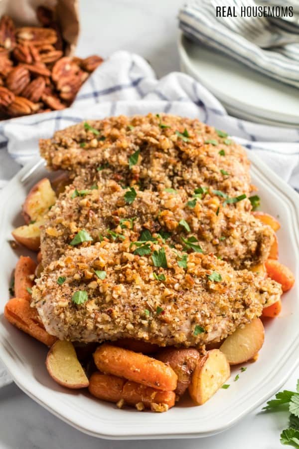 pecan chicken on a serving platter with vegetables