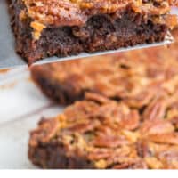 pecan pie brownie on a spatula over the pan with recipe name at the bottom