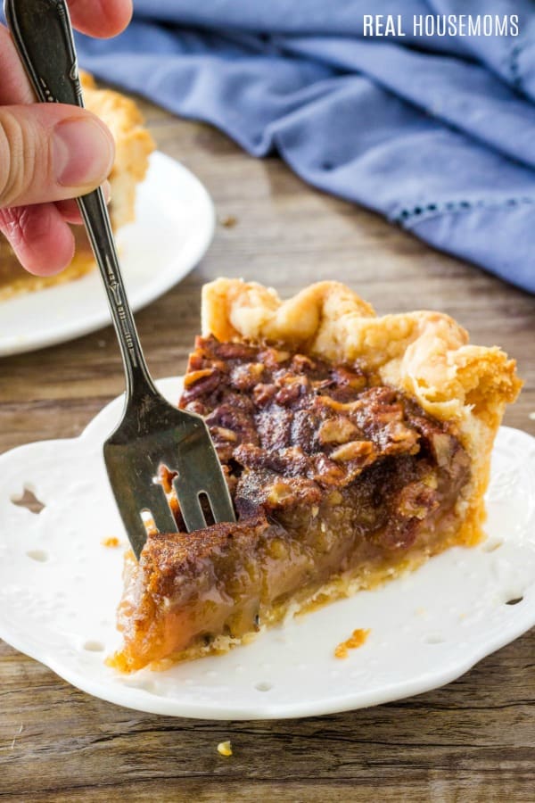 fork getting a bite of pecan pie from a slice