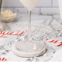 peppermint bark martini with a candy can garnish with recipe name at the bottom
