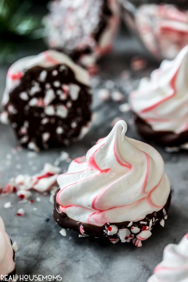 Close up of a Peppermint Bark Meringue surrounded by other meringues and crushed candy canes