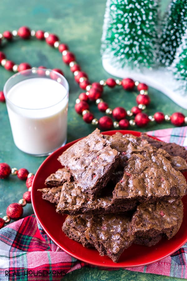 Peppermint Brownie Brittle piled up on a serving plate along side a glass of milk