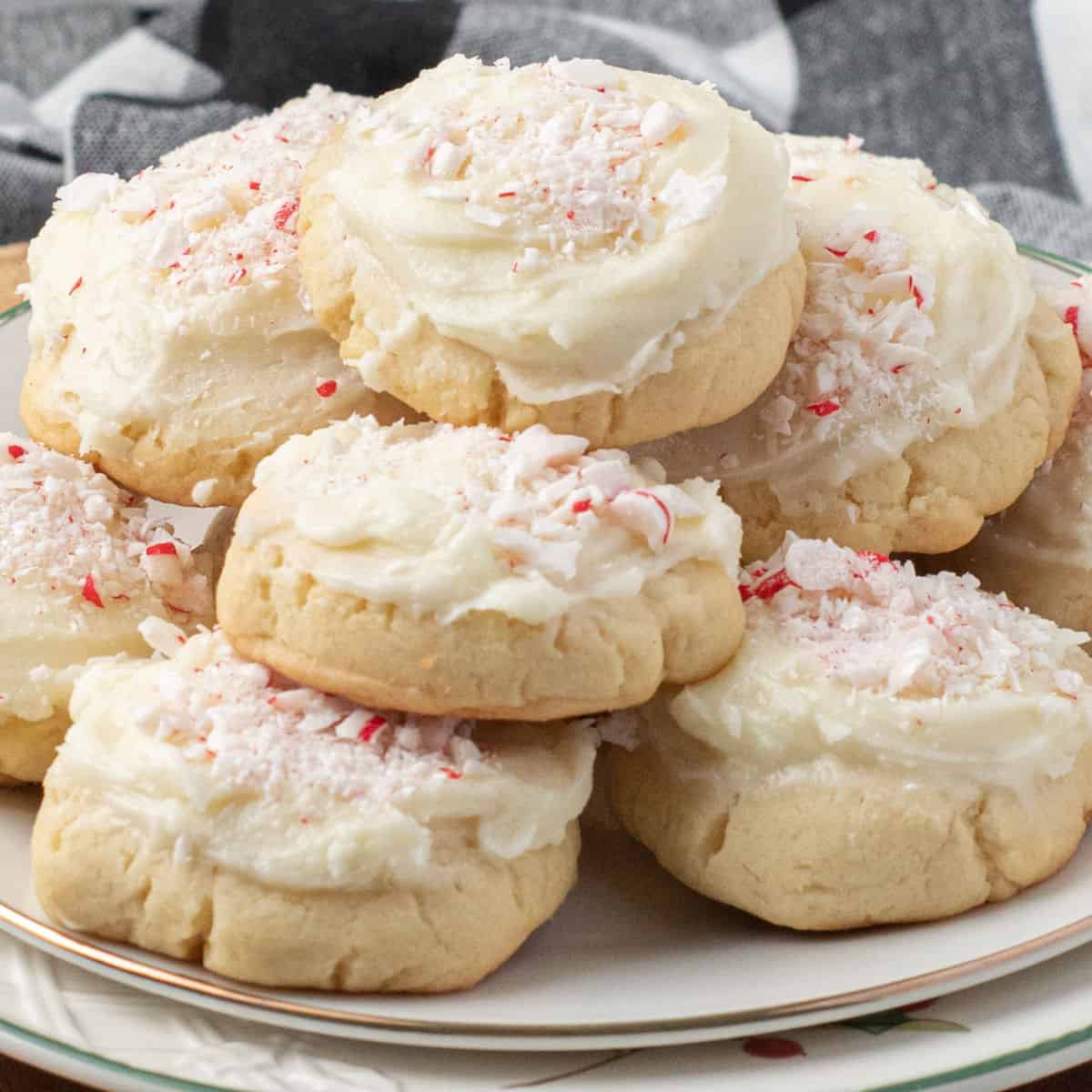 square image of peppermint sugar cookies piled up on a plate