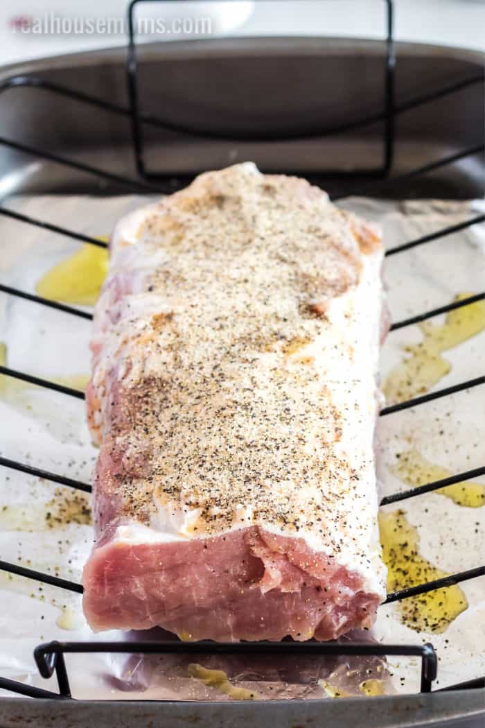 pork loin rubbed with oil and spices on a roasting rack