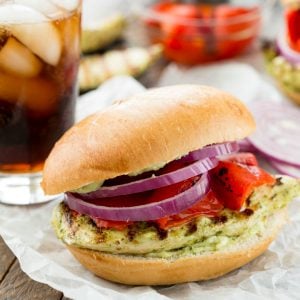 This Grilled Pesto Chicken Sandwich is delicious topped with a pesto mayonnaise, roasted bell pepper, and purple onion!