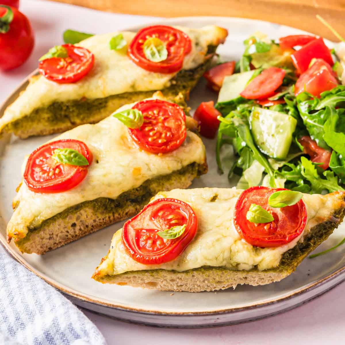 square imagePesto French Bread Pizza is a mouth-watering appetizer featuring a combination of warm bread, flavorful pesto, gooey cheese, and tomatoes!