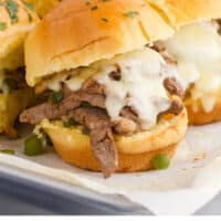 philly cheesesteak sliders on a baking sheet with recipe name at the bottom