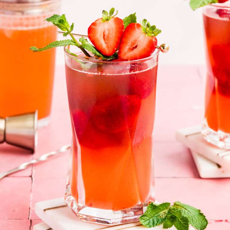 square image of a strawberry mint pimm's cocktail on a coaster