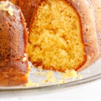 pineapple bundt cake with a section cut out to show inside with recipe name at the bottom