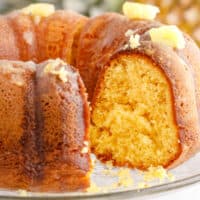 square image of pineapple bundt cake with a slice removed to show the cake crumb