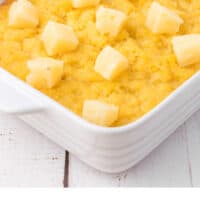 side view of pineapple casserole in a dish with recipe name at the bottom