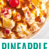 looking down at pineapple upside down fluff topped with caramel in a bowl with recipe name at the bottom