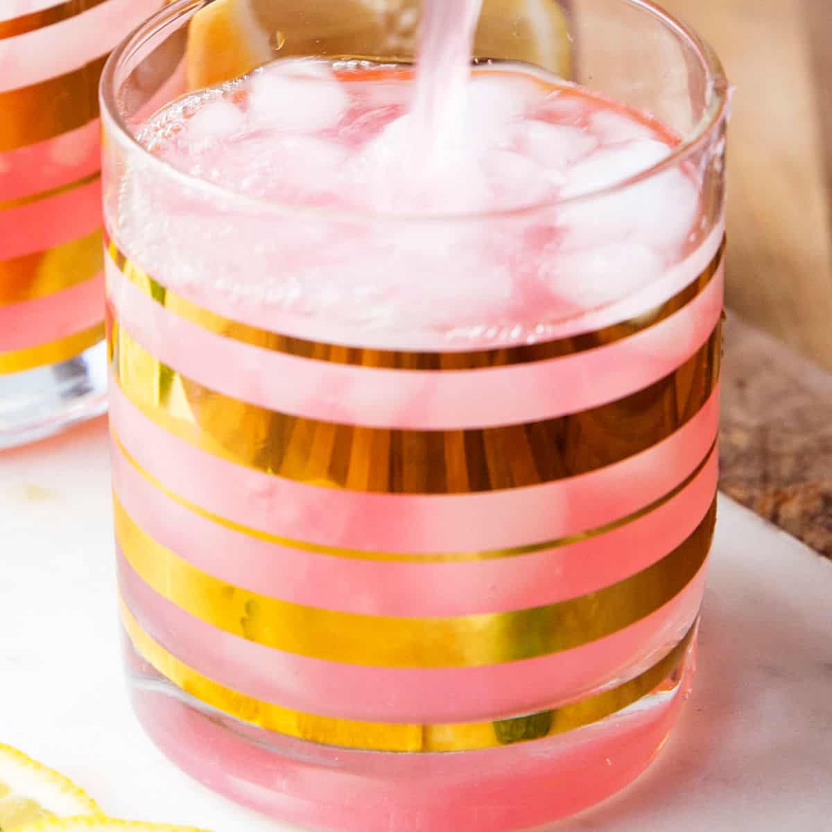 square image of moscato pink lemonade punch being poured into a glass
