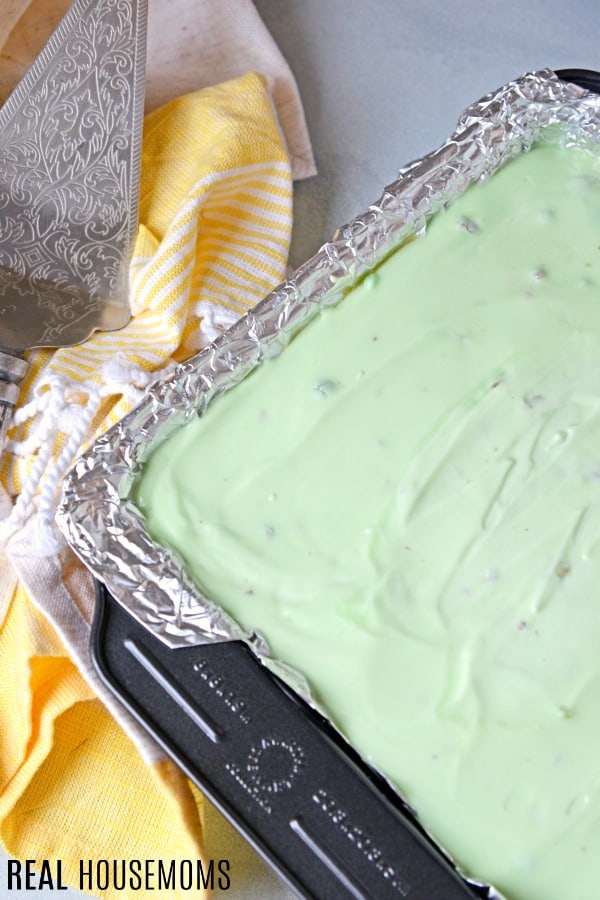 Lined baking dish filled with pistachio icebox cake, ready to be refrigerated