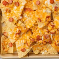 close up of pizza nachos with recipe name at the bottom
