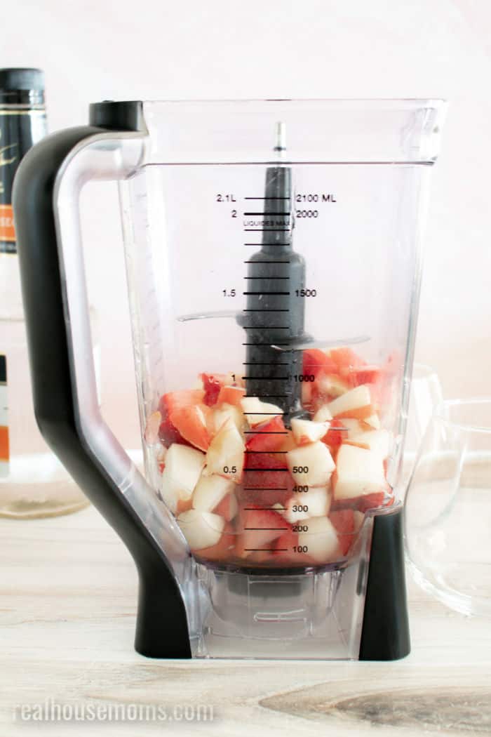 blender with chopped peaches and plums
