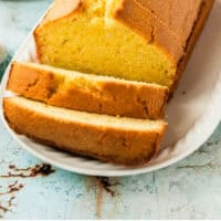 pound cake with a few slices cut from the front on a platter with recipe name at the bottom