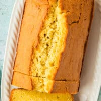 image of pound cake with a few slices cut from the front of the loaf with the title of the post on top of the image in pink and black lettering